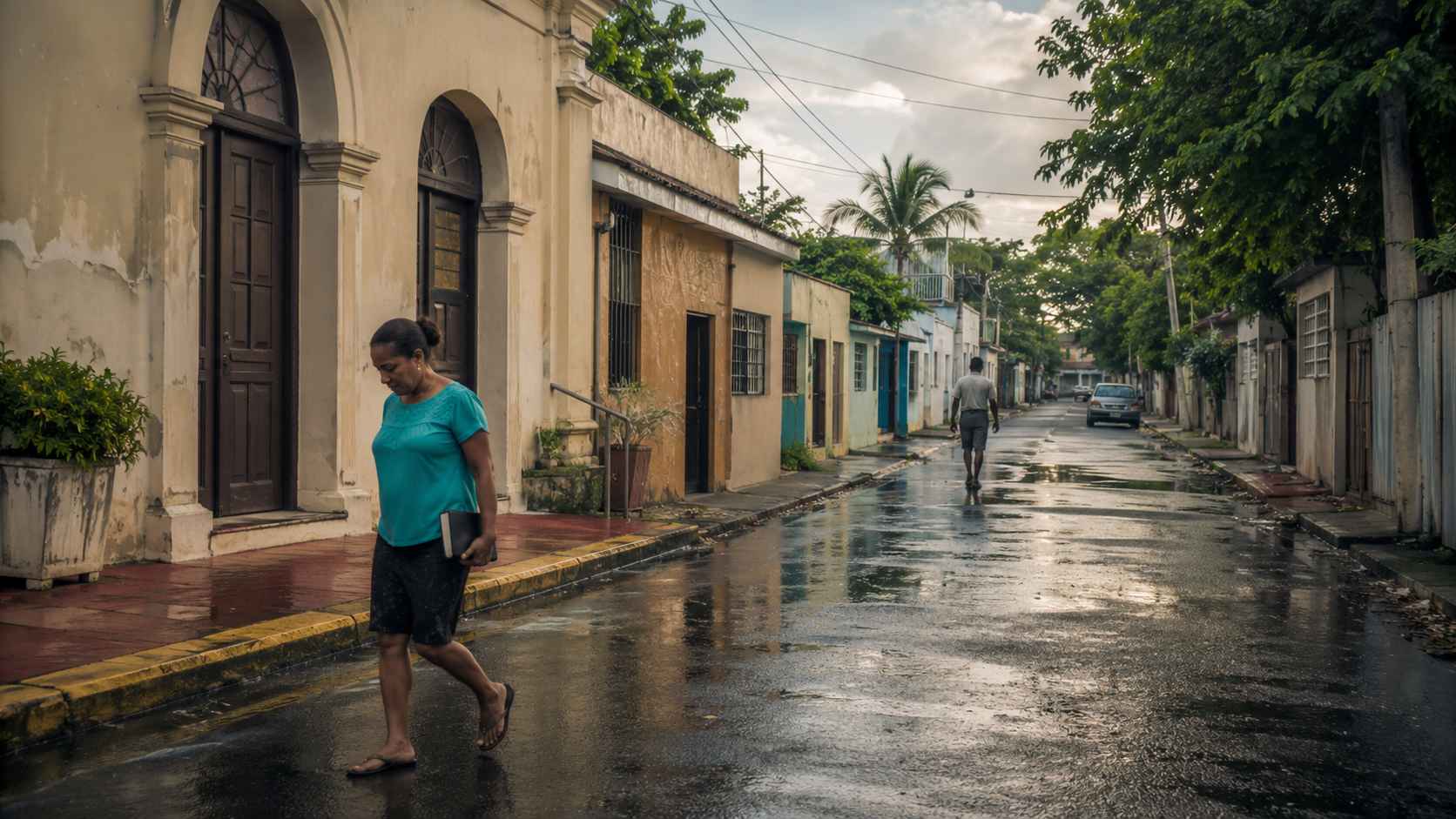 Rain-wet neighborhood street in the Dominican Republic with modest Caribbean buildings, an arched church-like entrance, and two adults walking quietly.