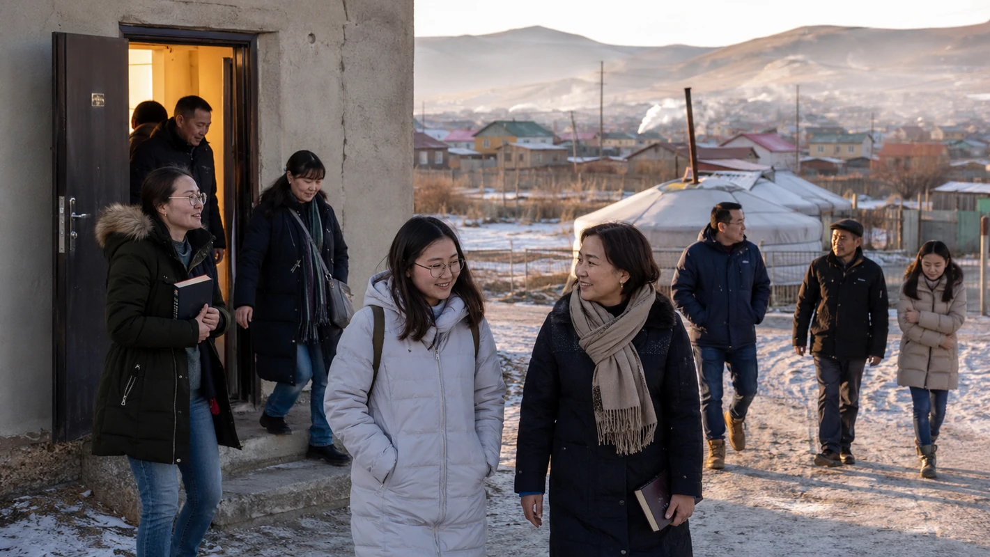 Mongolian adults walking together outside a modest building in a snowy Ulaanbaatar ger district.